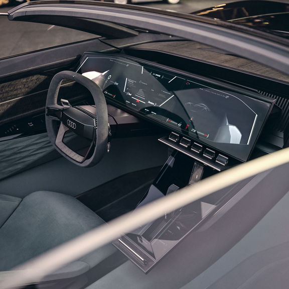 A view of the driver’s seat, pedals, steering wheel, and monitors in “Sports” mode on the Audi skysphere concept.