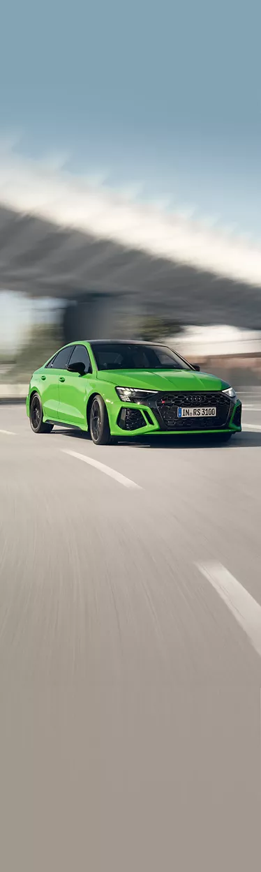 Audi RS 3 sedan on the road in side view