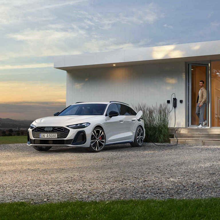 Audi A5 Avant e-hybrid Charging with a man standing in the doorway