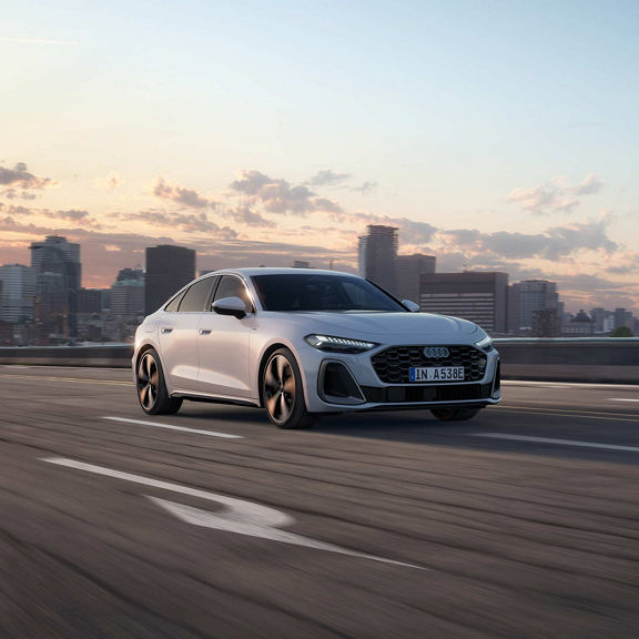 Audi A5 saloon e-hybrid dynamic side view on a road