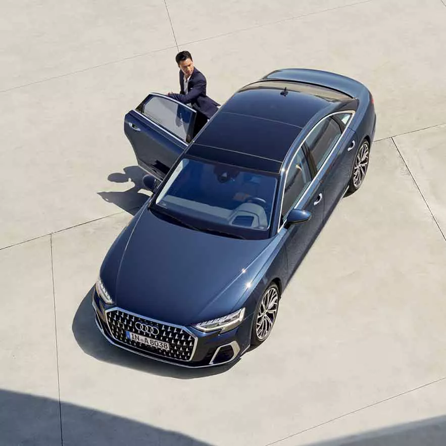top view of Audi A8 L with a man coming out of the rear door