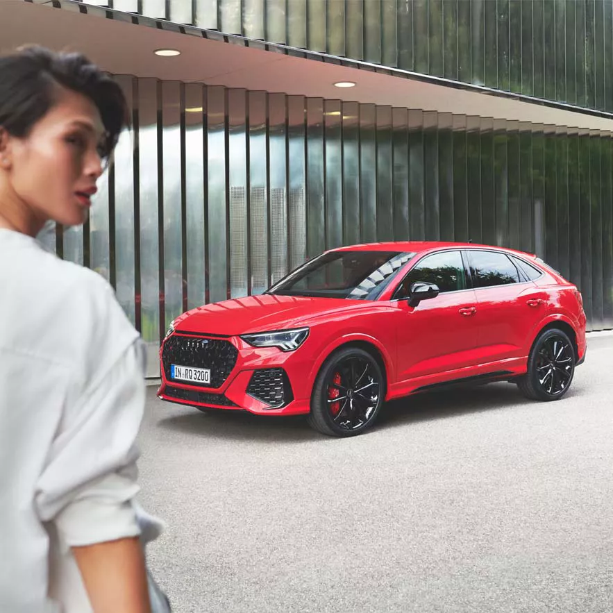 Audi Rs Q3 Sportback side front view with a woman