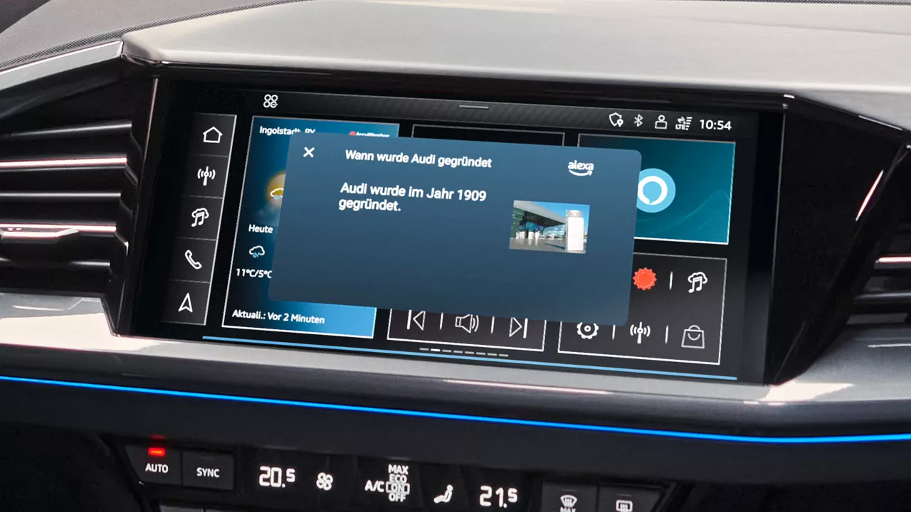 Closeup shot of the screen in the center console. The question “When was Audi founded?” appears. On the screen. Amazon Alexa answers "Audi was founded in 1909 by August Horch." 