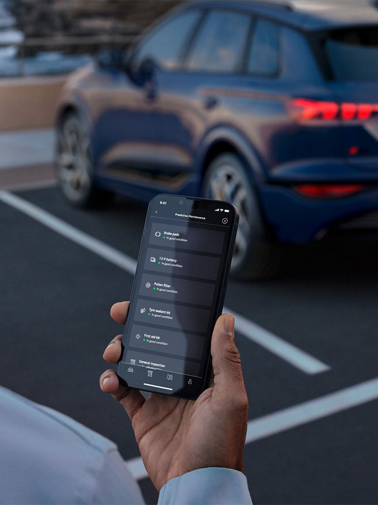 Man holding smartphone with the myAudi app