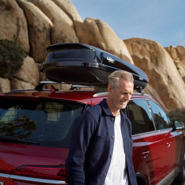 The Audi Q7 in the background with travel luggage