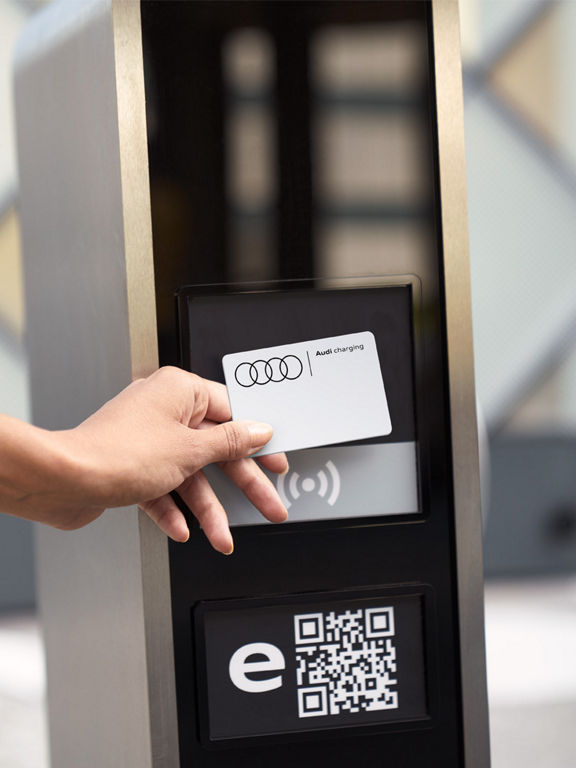 Man with smartphone in front of Audi Q8 Sportback e-tron