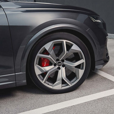 Audi RS Q8 rear view with female model