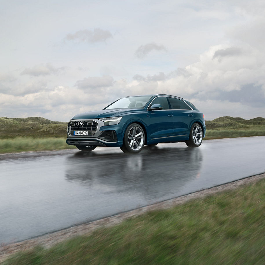 An Audi Q8 driving on a road