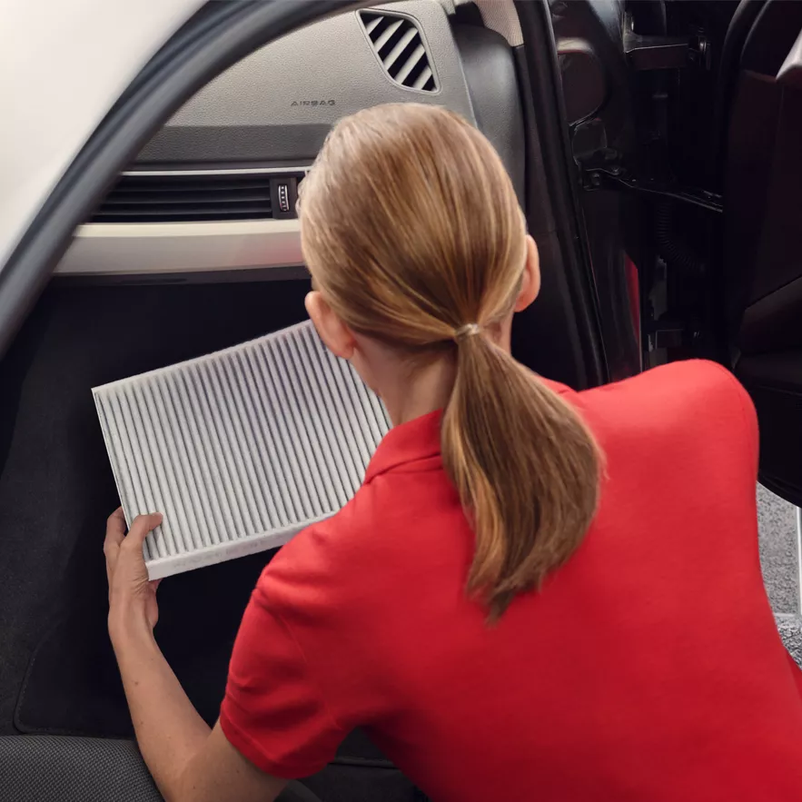 Audi technician inspecting a car