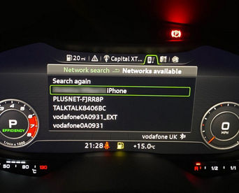 An Audi dashboard screen displaying Wi-Fi settings with a blurred out network name selected