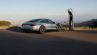  Electric Audi vehicle charging at a station with scenic city view in background