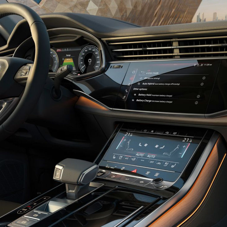 Interior of an Audi vehicle showing a digital dashboard and touchscreen control panels