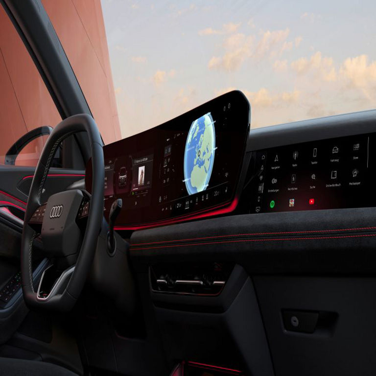 An Audi vehicle interior with a digital dashboard displaying navigation and multiple functions