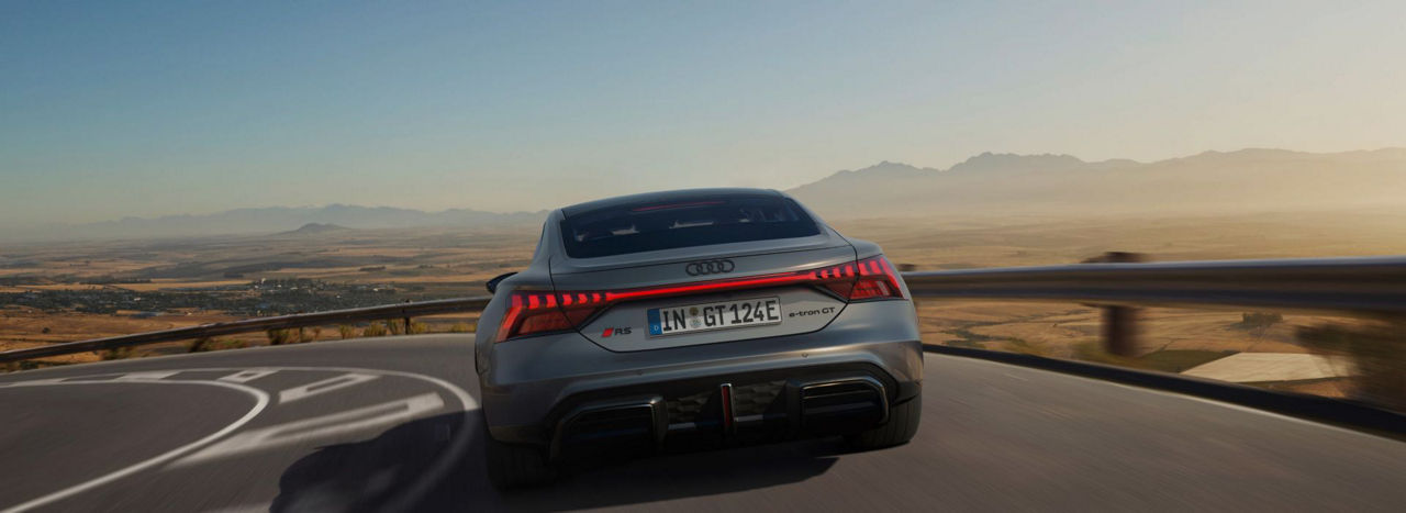 Back of an Audi electric RS e-tron GT driving on a road in