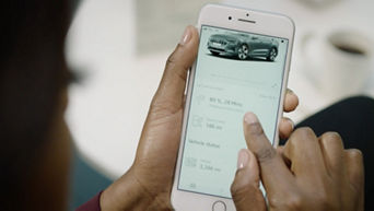 A person interacting with the myAudi app on their mobile phone, mobile screen the focal point