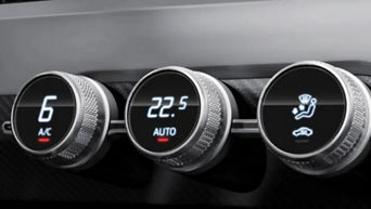 Close up of three air conditioning control dials with digital displays in an Audi vehicle