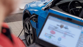 A blue Audi electric vehicle plugged in on charge at an Audi service centre 