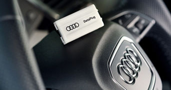 An Audi Data Plug sat on top of mid-section the steering wheel inside an Audi vehicle