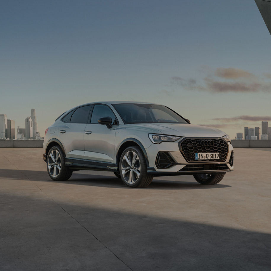 Audi Q3 on rooftop with skyline background