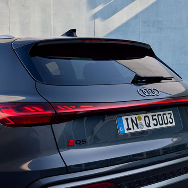 Rear view of a dark Audi Q5 with LED taillights and European license plate.