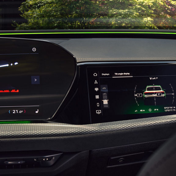Car's interior view of a digital display showing vehicle tilt angle and GPS coordinates with ambient lighting.