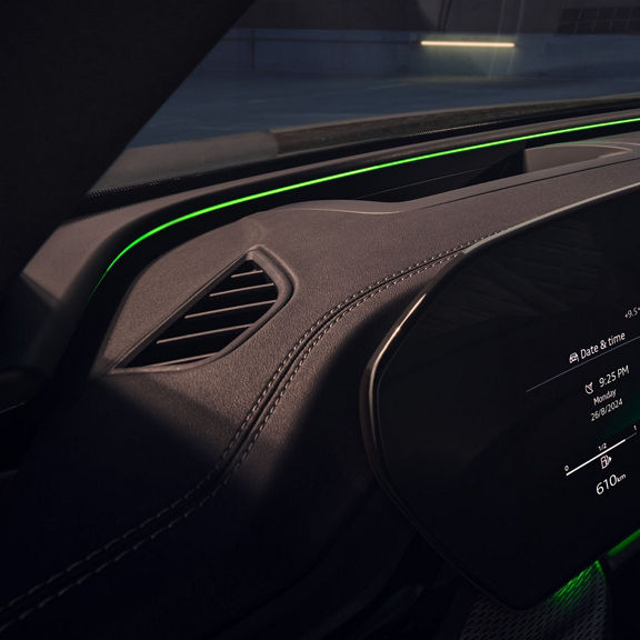Interior of a car showcasing its digital dashboard and ambient lighting.