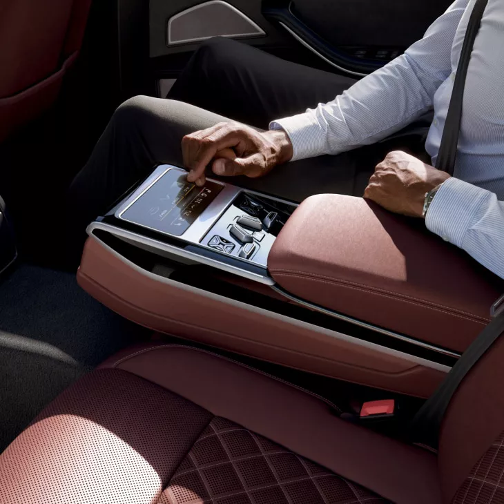 interior view of man using tablet inside Audi A8 S8 with brown interior