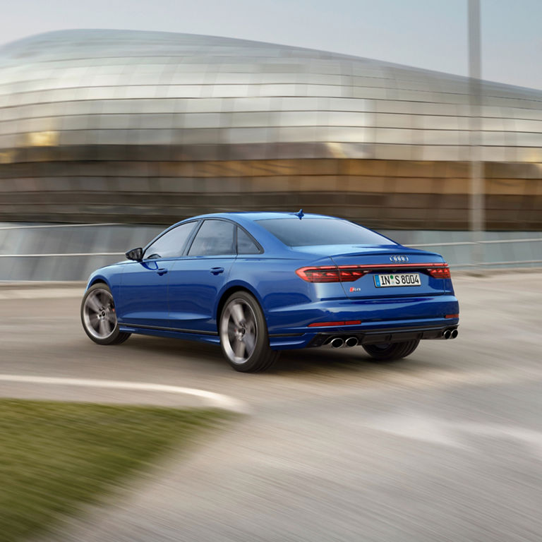 Rear view of blue Audi A8 S8 near building