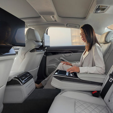 rear view of lady in A8 S8 on back seat using touchscreen device