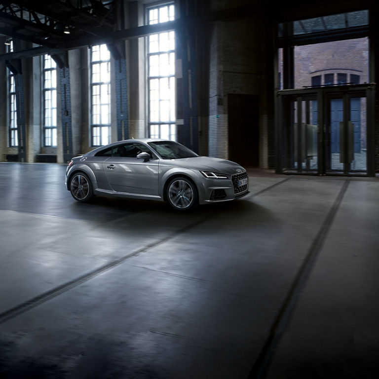 Silver Audi TT in an empty building.