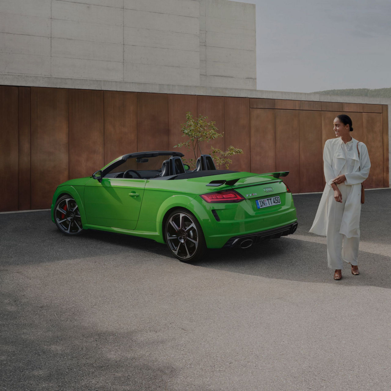 Lady walking away from green TT RS Roadster