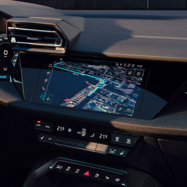 Car dashboard with modern infotainment system displaying GPS navigation map.