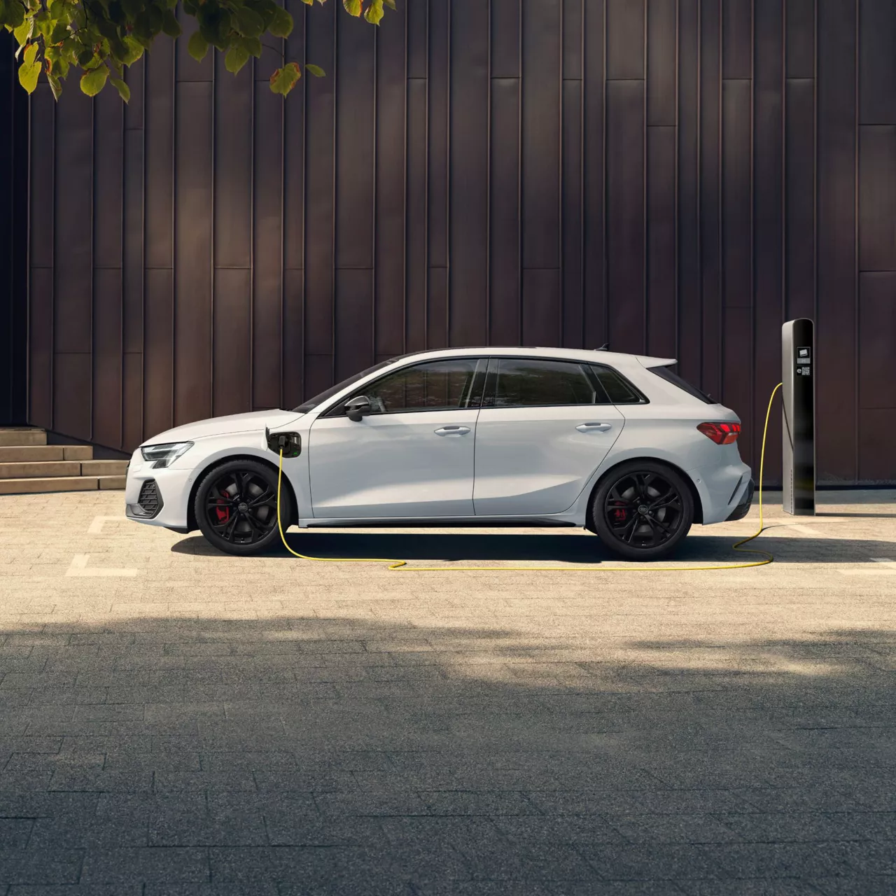 White electric car charging at a public charging station.