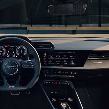 Interior view of an Audi car focusing on the steering wheel and dashboard.