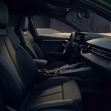 Interior view of a car with leather seats, dashboard, and steering wheel.