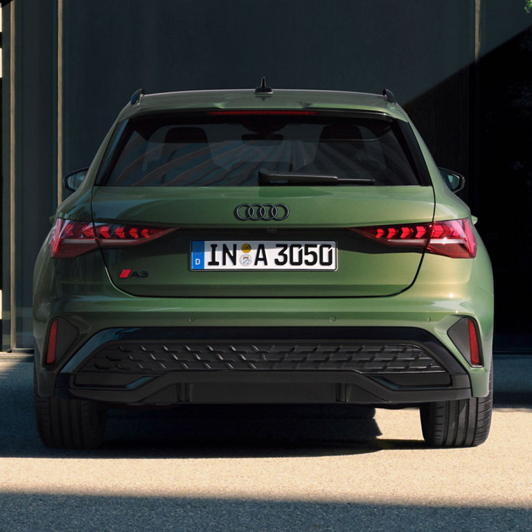 Rear view of a green Audi car with distinctive taillights and license plate "IN-A 3050".