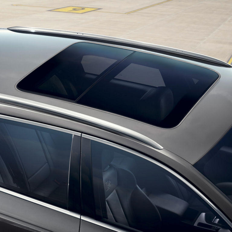 Close-up view of a car's panoramic sunroof on a grey vehicle.