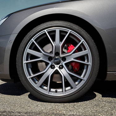 Close-up of an Audi's alloy wheel with red brake calliper.