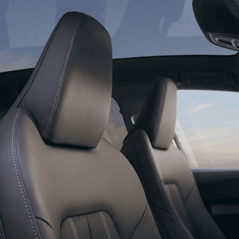 Car's interior with modern leather seats and panoramic sunroof.