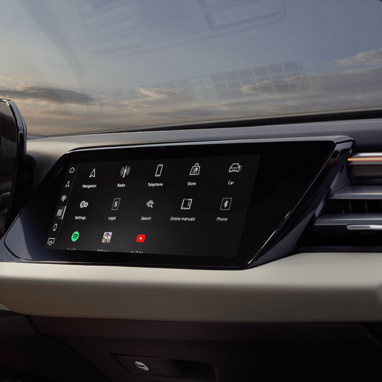 Car infotainment touchscreen displaying various icons like navigation, radio, and phone.