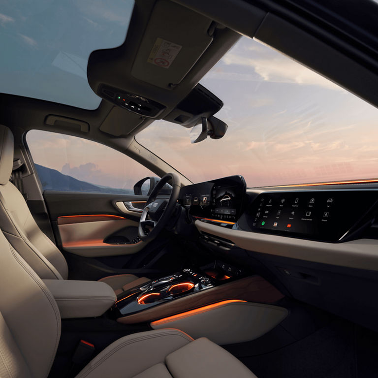 Car's interior at dusk with ambient lighting and advanced dashboard displays.