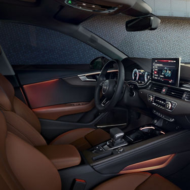 Car's interior with leather seats, modern dashboard, and steering wheel.