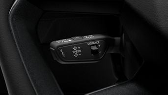 Car's steering wheel-mounted cruise control settings with distance adjustment options.