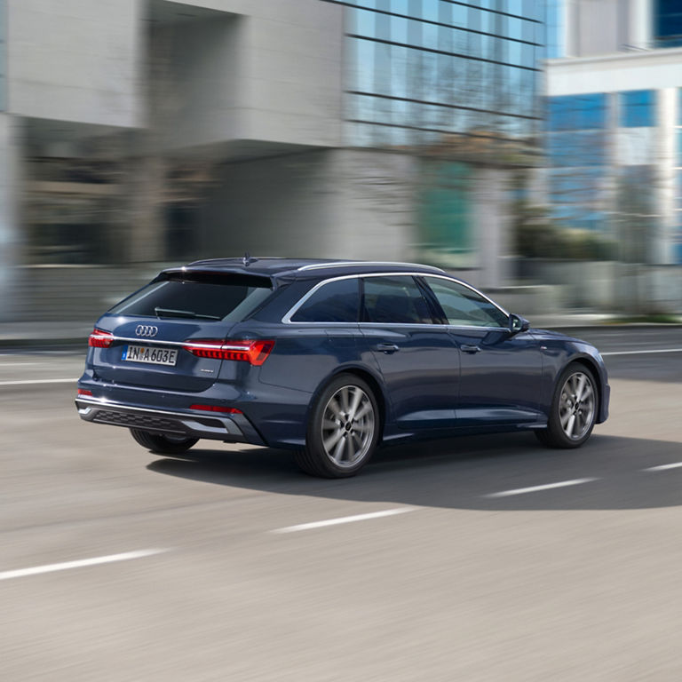 Blue Audi car in motion on a city street.