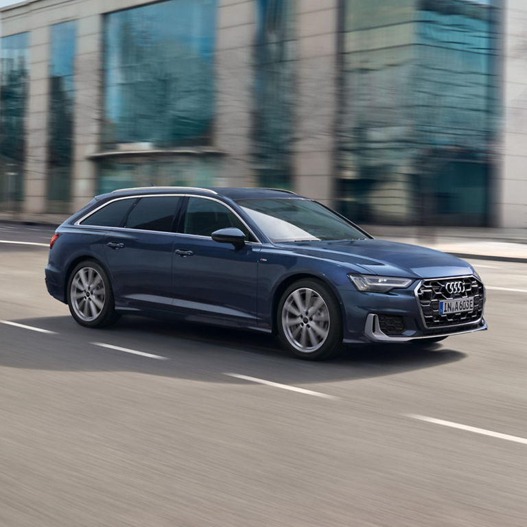 A moving blue Audi car with a blurred background.