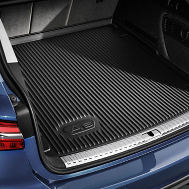Trunk of a blue car showcasing a protective ribbed liner.