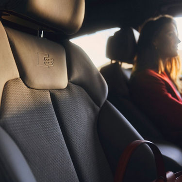 Interior of a car showing a close-up of a leather seat.