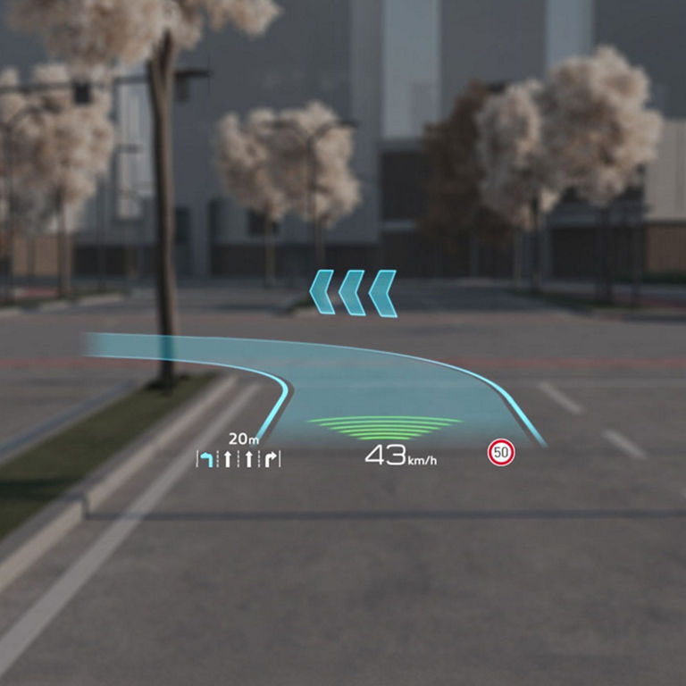 Heads-up display (HUD) on a car windshield showing speed and navigation information.