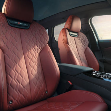 Car interior with red leather diamond-stitched seats.