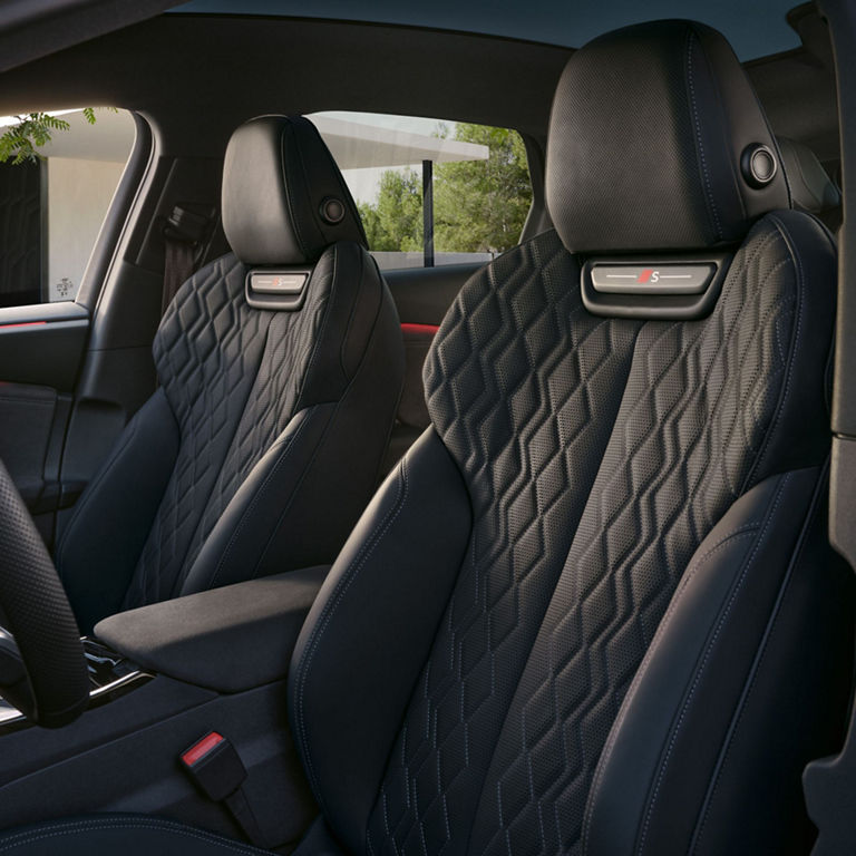 Interior view of a car with black leather seats and a modern design.